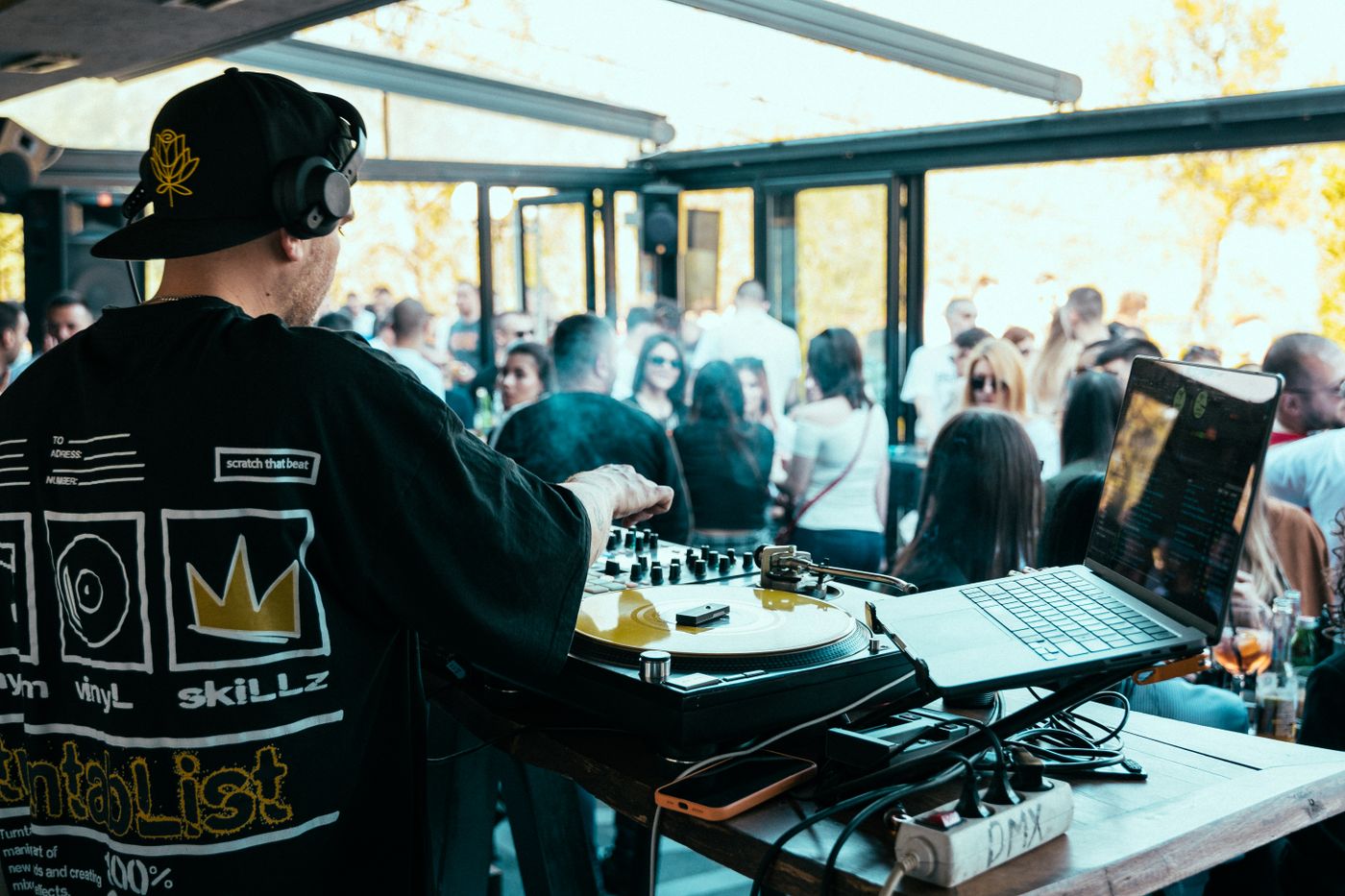 DJ performing at a lively modern outdoor event