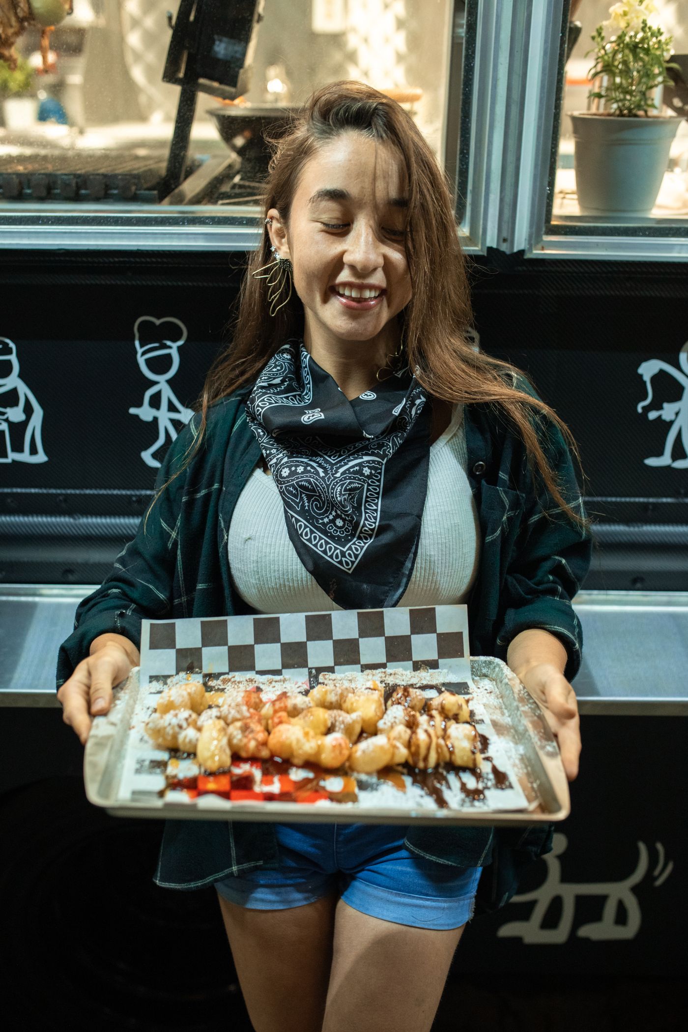 Food vendor presenting fresh pastries at a modern market