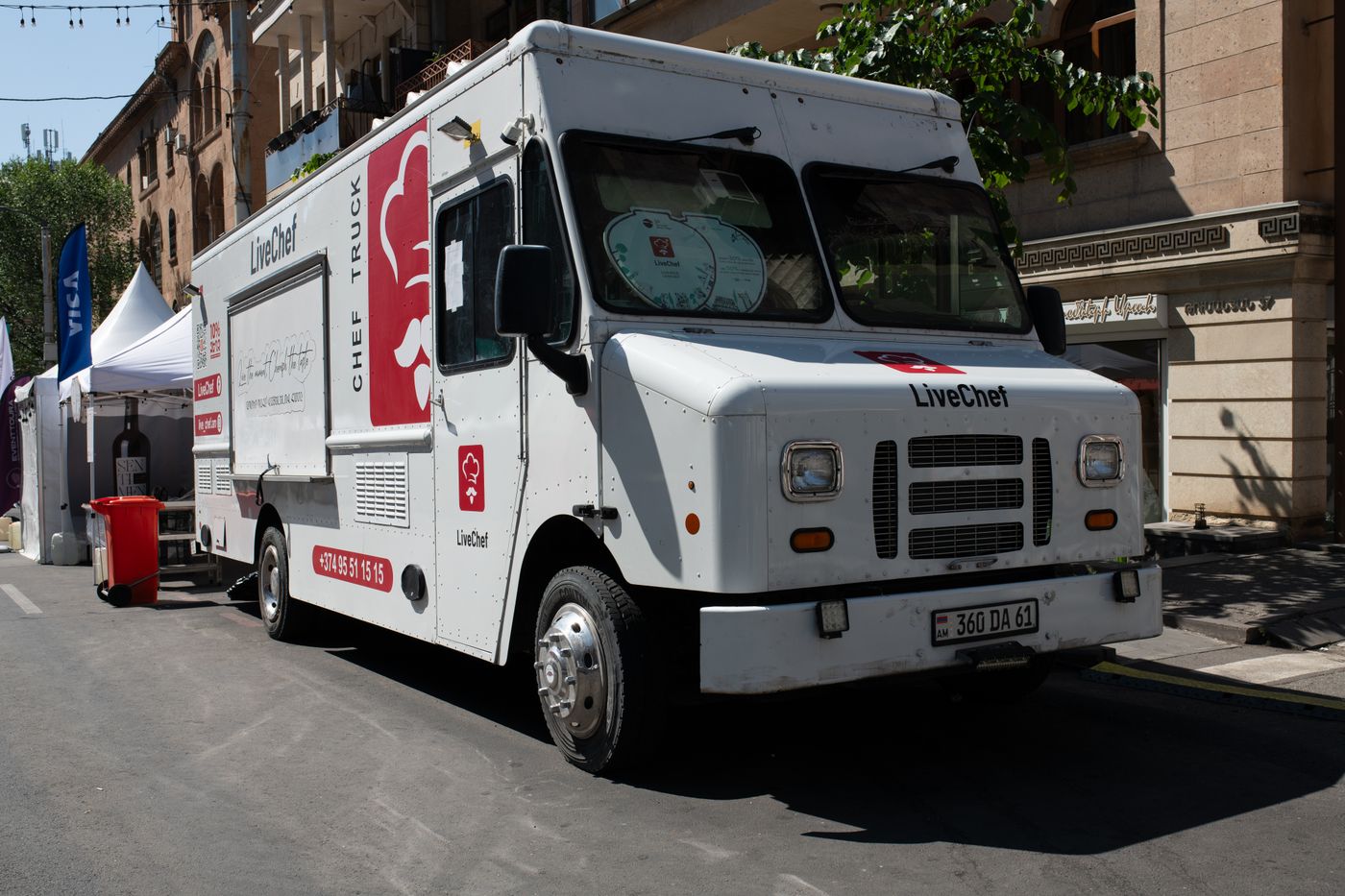 Modern food truck serving guests at a sunny outdoor festival