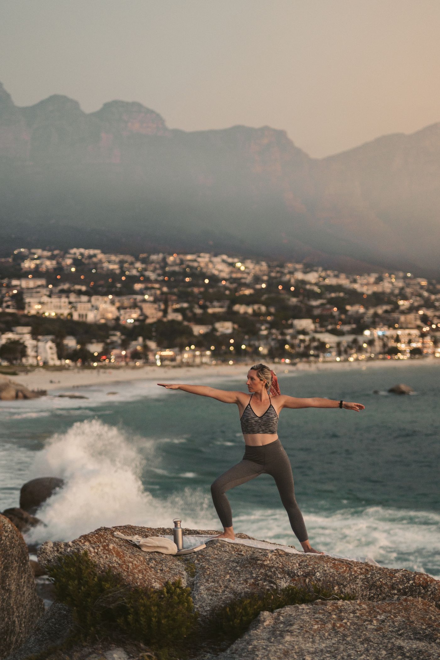 Woman practicing outdoor yoga at sunset in Cape Town