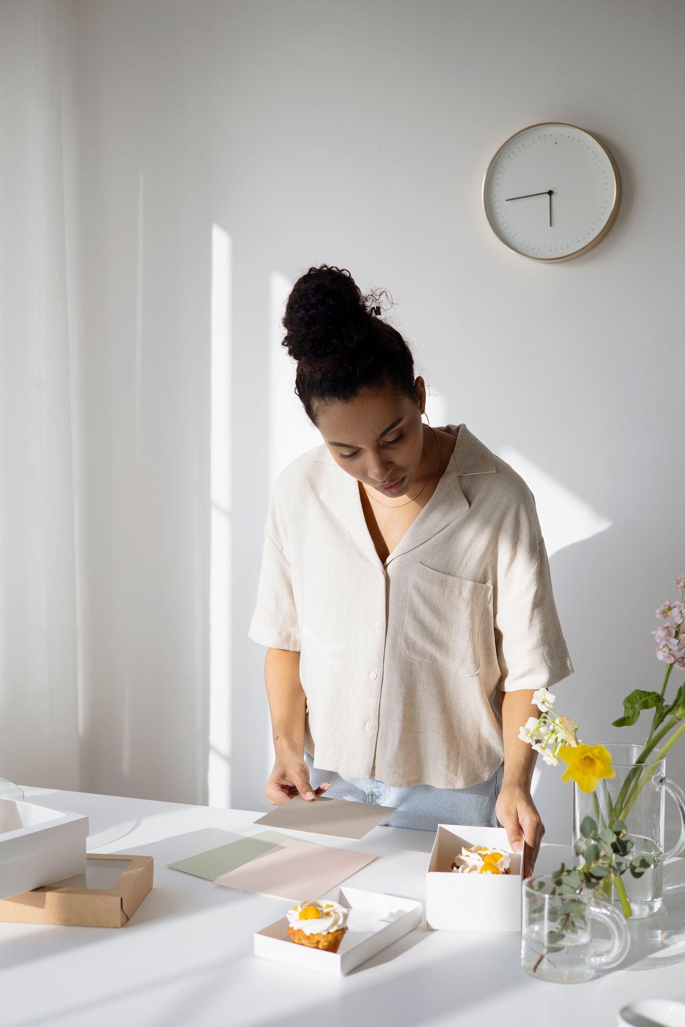 Woman entrepreneur preparing and packaging cupcakes